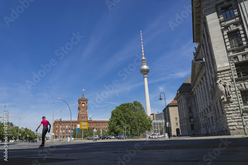 Photography Rotes Rathaus Berlin mit Fernsehturm und Skater an einem sonnigen Tag mit blauem Himmel