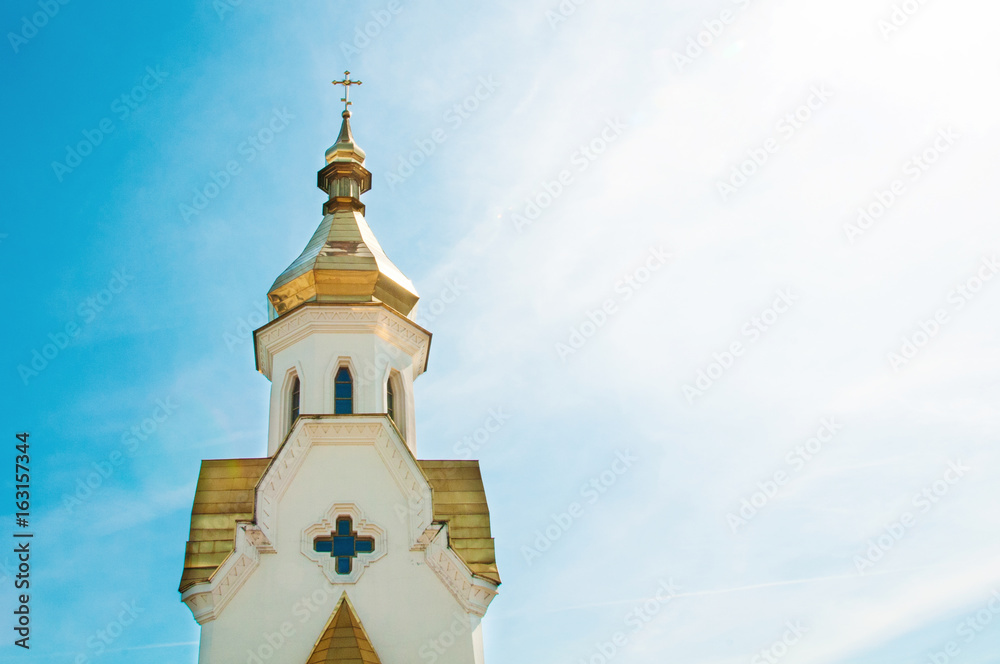 Golden domes of the church against the sky.