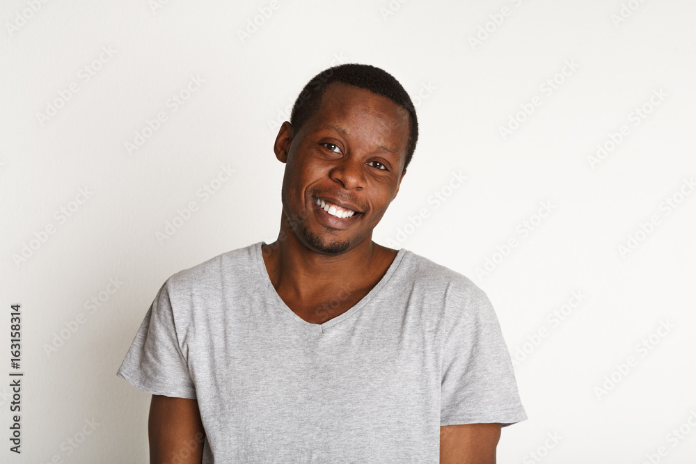 Facial expression, emotions, friendly black man smiling Facial expression, emotions, friendly black man smiling