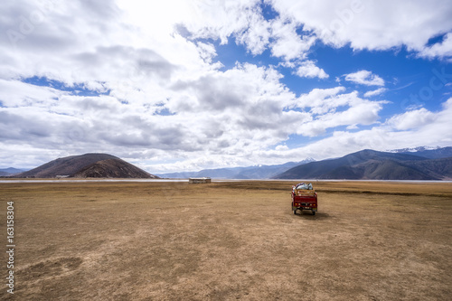 Napa Hai Nature Reserve: Tricycle in the field Deqen Tibetan Autonomous Prefecture, Yunnan, China. photo