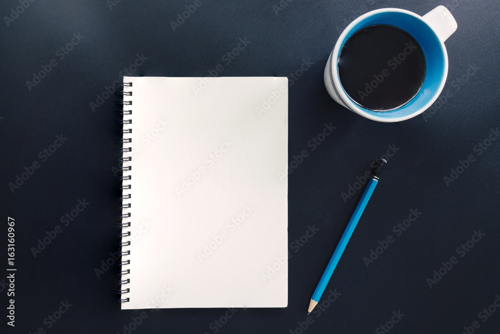 Office table with blank notepad, pencil, and cup of coffee. Office table with blank notepad, pencil, and cup of coffee.