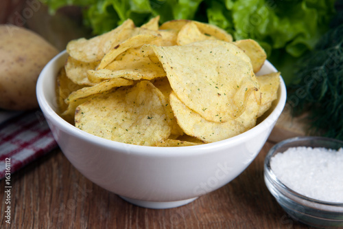still life from a glass bowl with potato chips