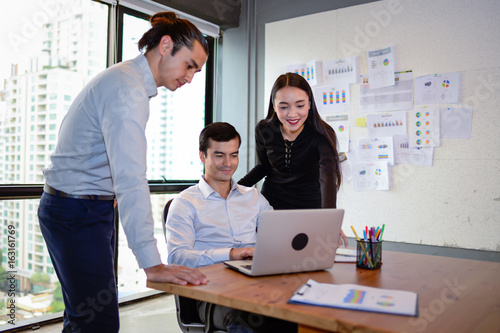 businessman and businesswoman smile and discussing ideas at business meeting in office