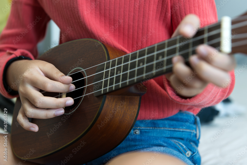 Hand playing ukulele