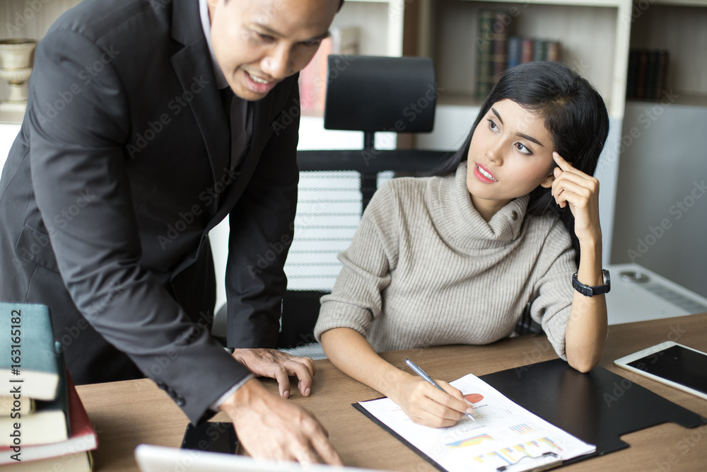 Fototapeta premium Asian businessman training to secretary about how to work at office, man with relax time concept.
