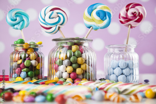 Different colorful sweets and lollipops and gum balls