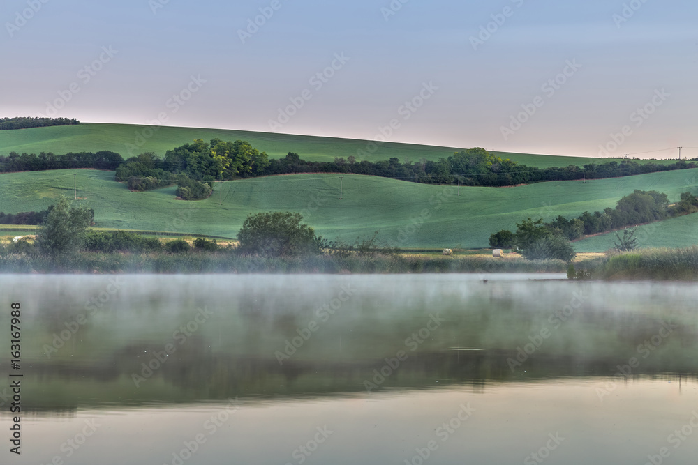 At early morning a foggy at lake scenery in Moravian Tuscany in Czech republic.
