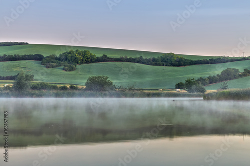 At early morning a foggy at lake scenery in Moravian Tuscany in Czech republic. © dmpalino