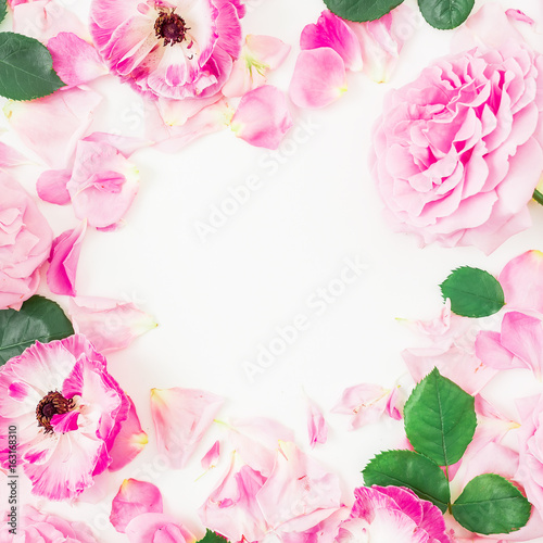 Pink rose flowers, leaves and petals on white background. Flat lay, top view. Round floral frame
