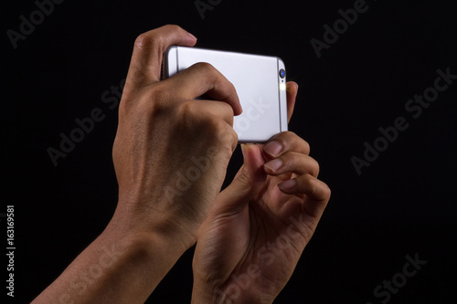 Photographer holding Smart phone on black background