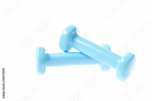 Dumbbells in cyan blue colour lying on each other