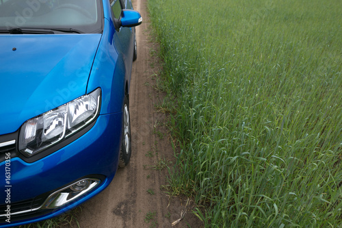 GOMEL, BELARUS - May 24, 2017: RENO LOGAN blue car is parked on the green field. photo