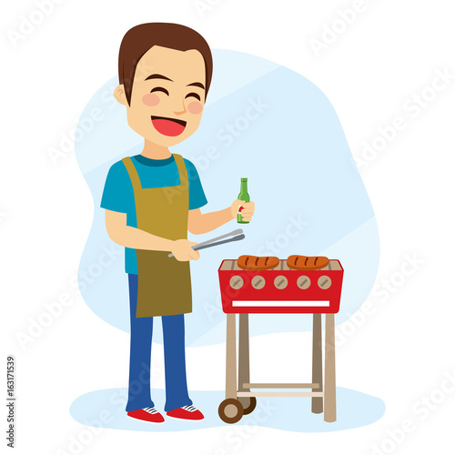 Young caucasian cheerful man cooking hamburger on barbecue grill