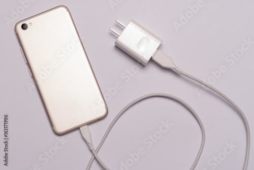 isolated of white smart phone, charger with cable