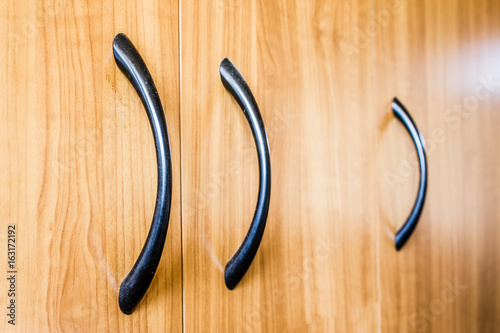 Furniture handle on wooden background photo