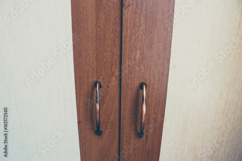 Furniture handle on wooden background photo