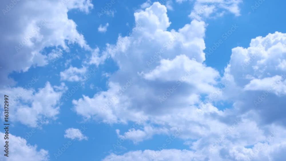 White clouds run against the blue spring sky White clouds run against the blue spring sky