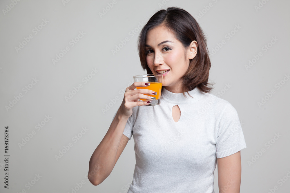 Young Asian woman drink orange juice. Young Asian woman drink orange juice.