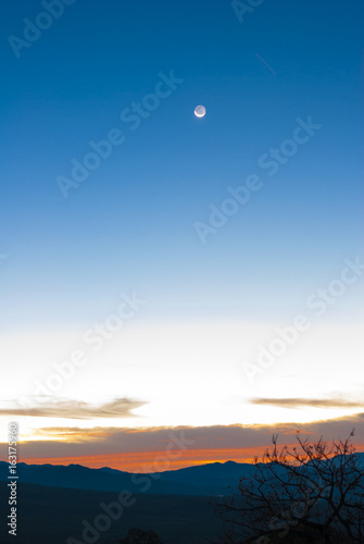 Sunrise clouds and mountains in Guatemala  dramatic sky with striking colors and moon. La Reunion.