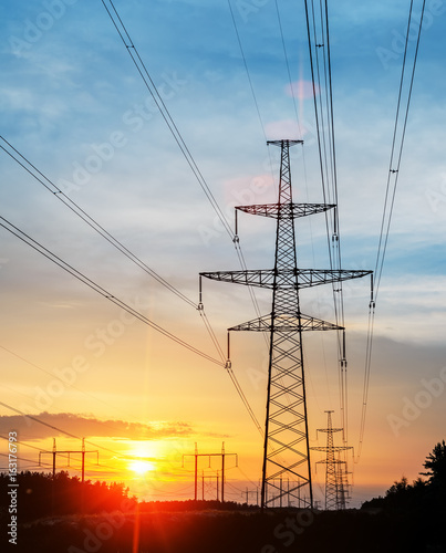 Electricity pylons and power lines, at sunset.