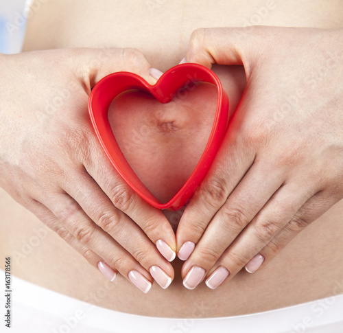 Pregnant woman holding a heart