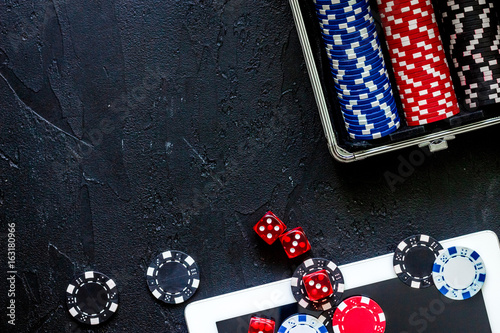 Poker set in a metallic case on a grey table top view copyspace photo