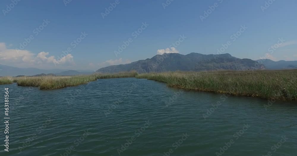 The Dalyan River with tourist boats in the straits of the river The Dalyan River with tourist boats in the straits of the river