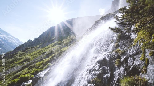 Wasserfall in den schweizer Alpen - Naturbelassene Berglandschaft mit dem Element Wasser in der Schweiz photo