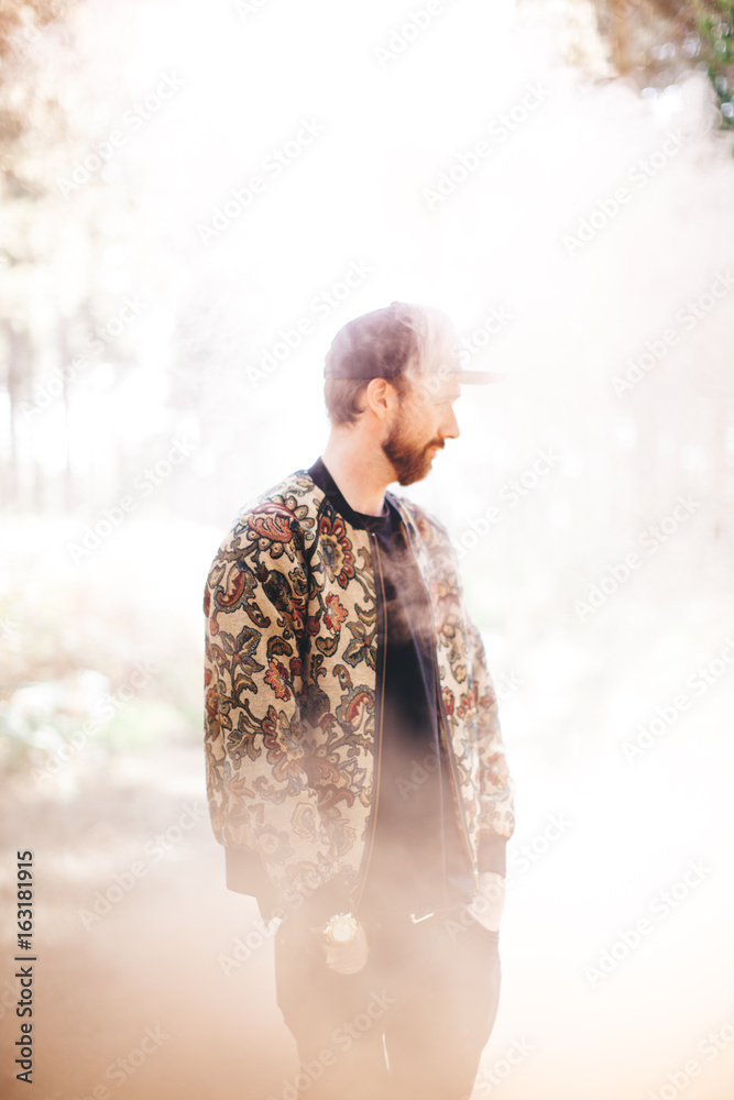Male in forest surrounded by smoke Male in forest surrounded by smoke