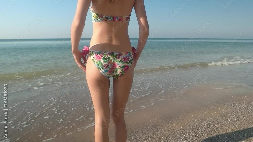 Lady dancing on seashore, slow-mo. Young woman wearing bikini. Lady dancing on seashore, slow-mo. Young woman wearing bikini.