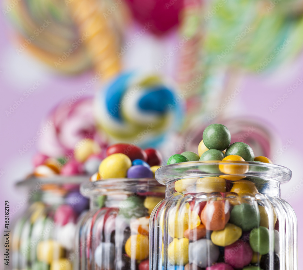 Glass jars in Colorful candies,lollipops and gum balls