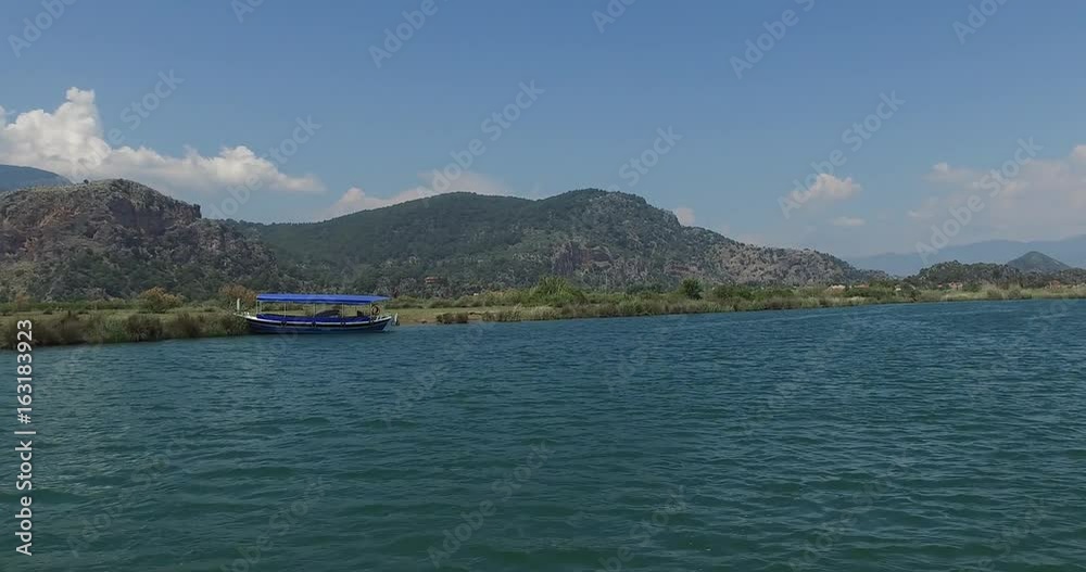 The Dalyan River with tourist boats in the straits of the river The Dalyan River with tourist boats in the straits of the river
