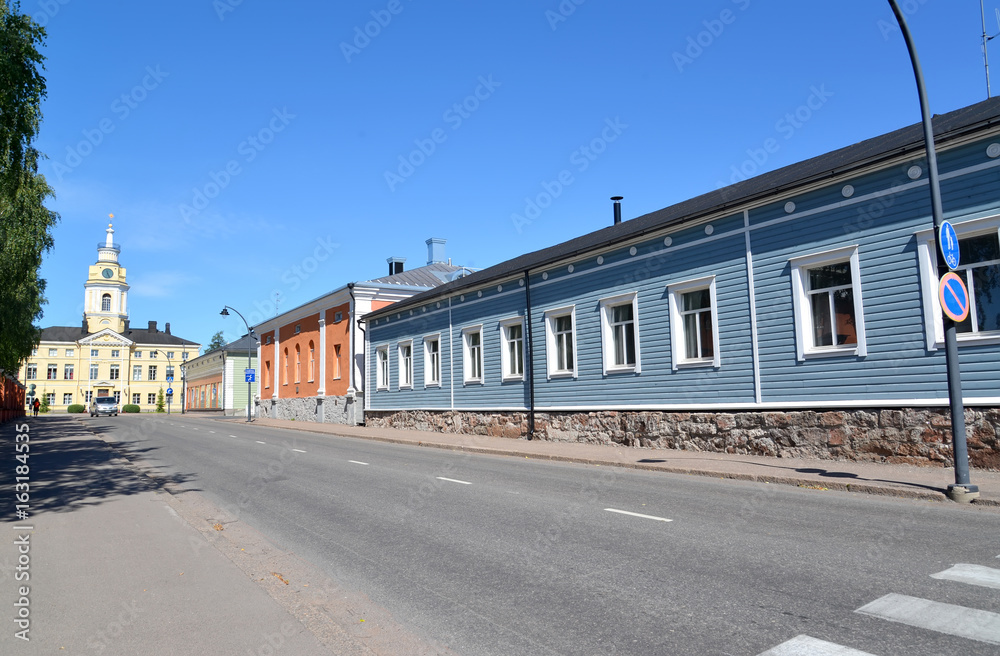 The street with one-storey houses overlooking a city town hall. Hamina, Finland