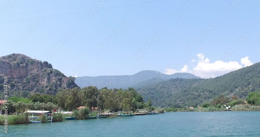 The Dalyan River with tourist boats in the straits of the river The Dalyan River with tourist boats in the straits of the river