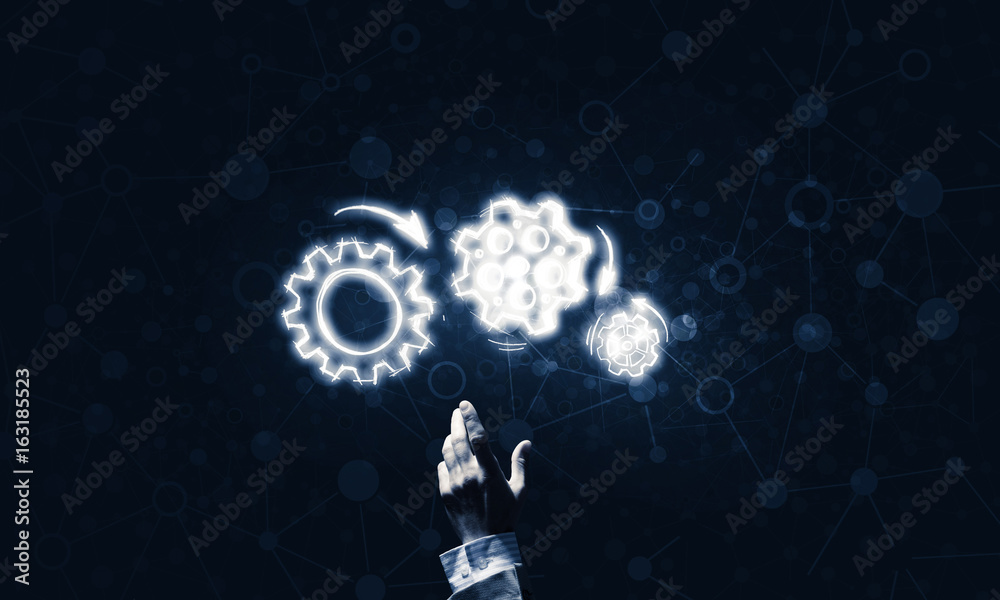 Glowing cogwheel mechanism icon on dark background as symbol of Glowing cogwheel mechanism icon on dark background as symbol of