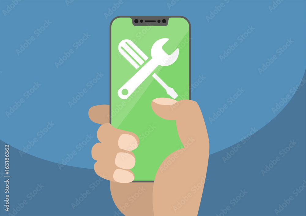 Wrench and screwdriver icon on modern bezel-free / frameless smartphone touchscreen.Hand holding smartphone as concept for fix, maintenance, repair or IT support. Wrench and screwdriver icon on modern bezel-free / frameless smartphone touchscreen.Hand holding smartphone as concept for fix, maintenance, repair or IT support.