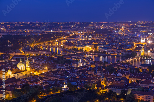 Prague at twilight blue hour, view of Charles Bridge on Vltava with Mala Strana, Old Town and Prague castle