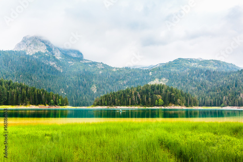 Mountains and Black Lake at cloudy daytime  Durmitor National Park  Zabljak  Montenegro. Beautiful landscape. Travel and vacation.