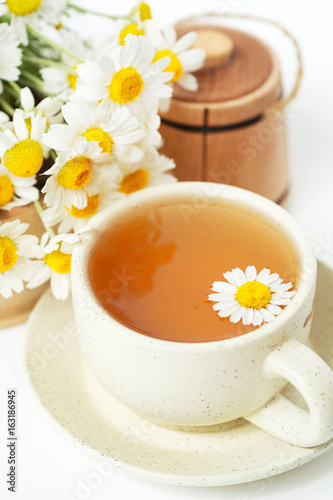 cup of herbal chamomile tea with fresh daisy flowers. doctor treatment and prevention of immune concept, medicine - folk, alternative, complementary, traditional medicine 