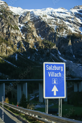 A road sign for Salzburg-Villach on the highway in Alps environment. photo