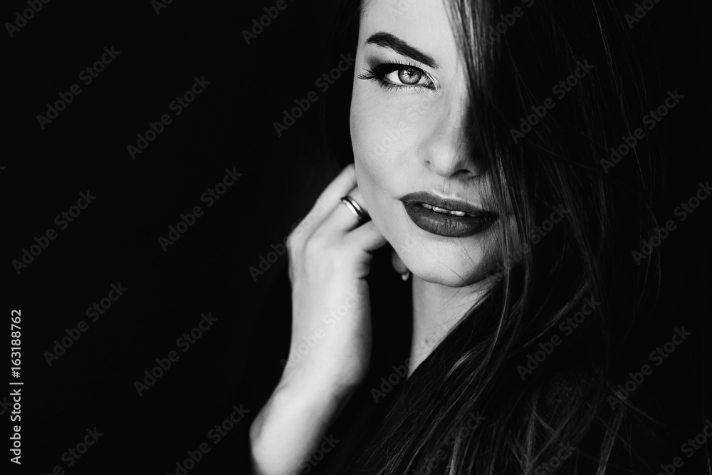 Contrast portrait closeup of beautiful woman on dark background Contrast portrait closeup of beautiful woman on dark background