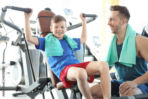 Dad and son training in gym