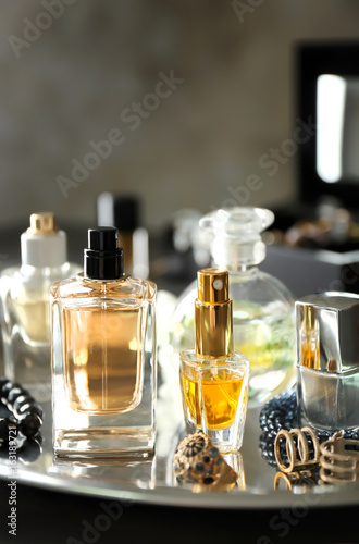 Tray with perfume bottles and accessories on table