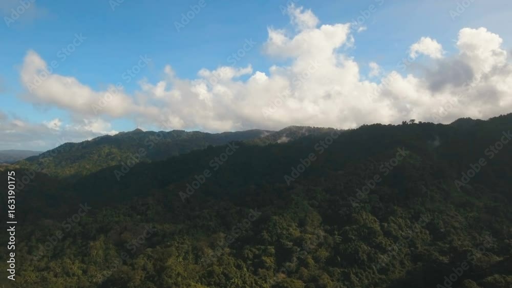 Aerial view: Mountains with rainforest covered with green vegetation and trees on the tropical island, landscape. Flying over mountains and hills with wild forest, sky clouds. Hillside rainforest and Aerial view: Mountains with rainforest covered with green vegetation and trees on the tropical island, landscape. Flying over mountains and hills with wild forest, sky clouds. Hillside rainforest and