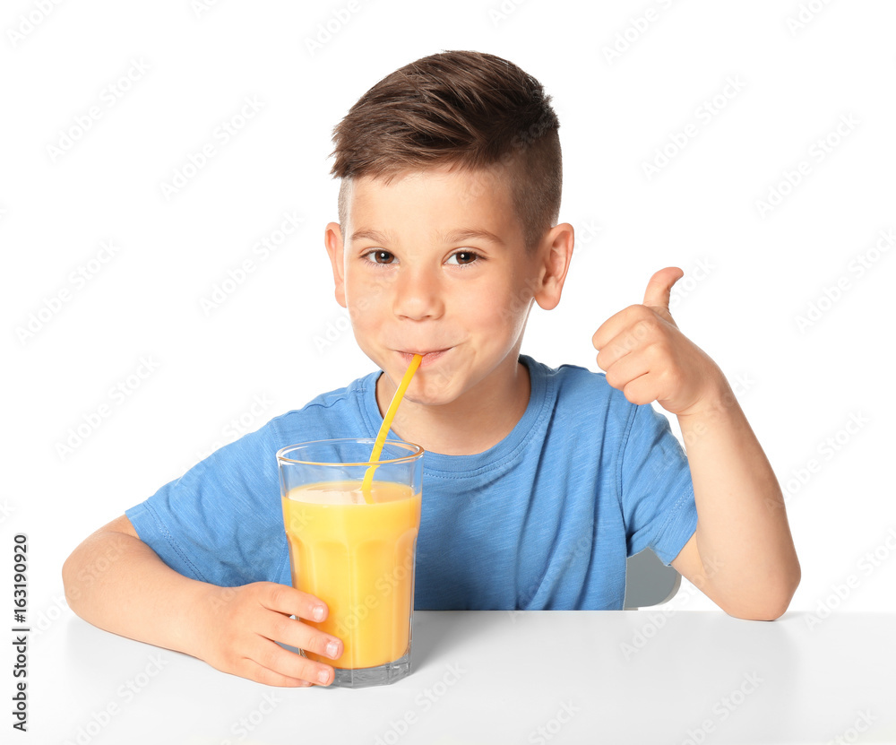 Cute little boy drinking juice on white background Cute little boy drinking juice on white background
