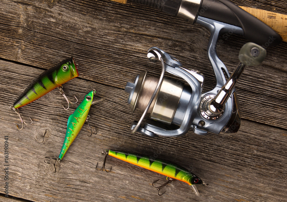 spinning rod And bait on a wooden background spinning rod And bait on a wooden background