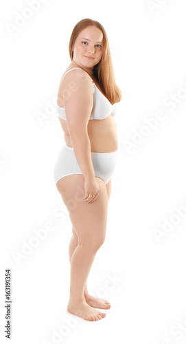Overweight young woman in underwear isolated on white. Diet concept © Africa Studio