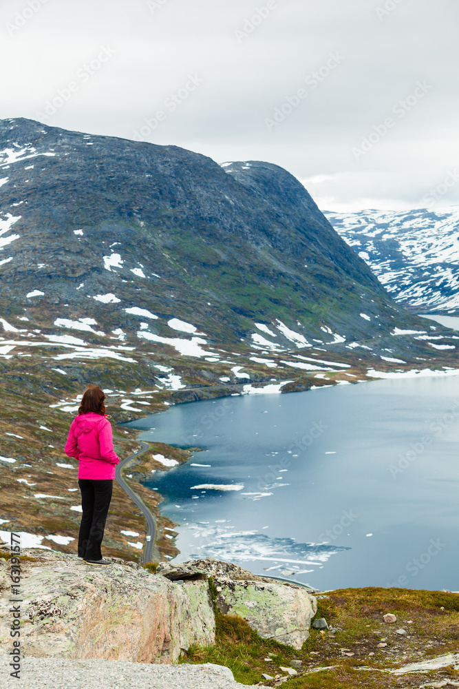 Tourist woman standing by Djupvatnet lake, Norway