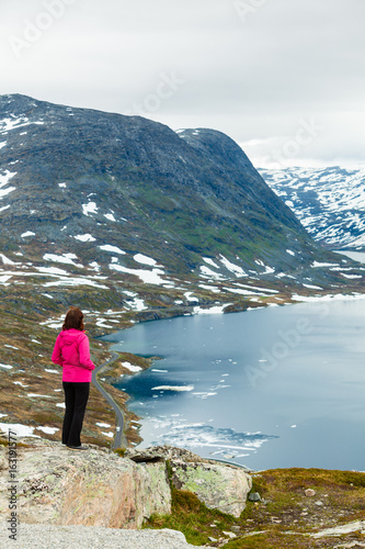 Tourist woman standing by Djupvatnet lake, Norway © Voyagerix