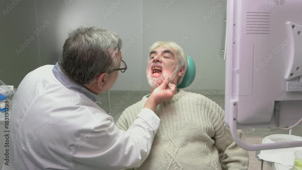 Elderly man at the dentist. Stomatologist is examining patient. High experience in medicine. Elderly man at the dentist. Stomatologist is examining patient. High experience in medicine.